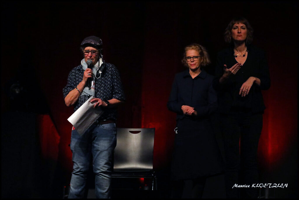 Photo de Chantal Leser et Hélène Dollfus sur scène et qui accueillent les spectateurs et derrière elles, Séverine qui fait la traduction en langue des signes française