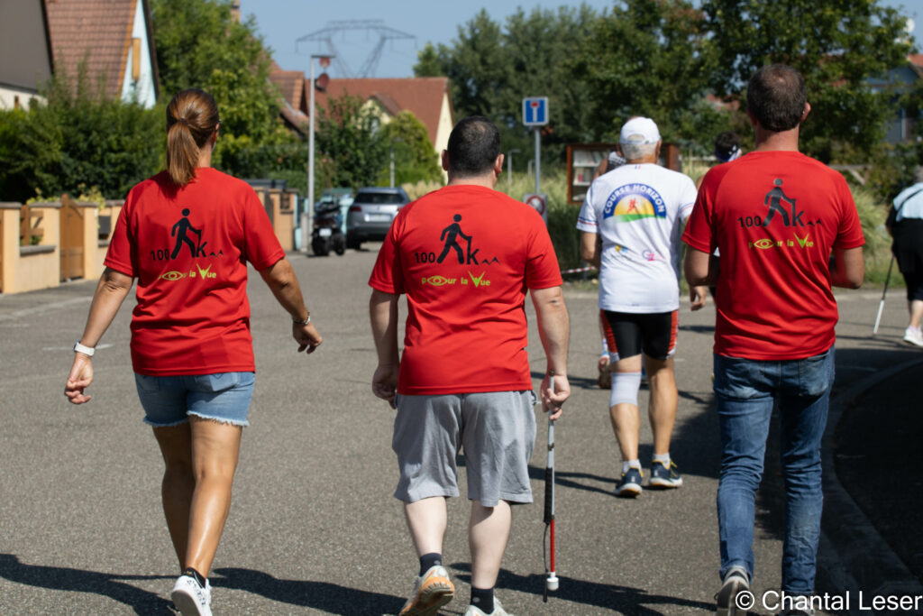 Stéphanie, Teddy et Sébastien vus de dos avec leurs tee-shirts des 100 km pour la vue en train de marcher